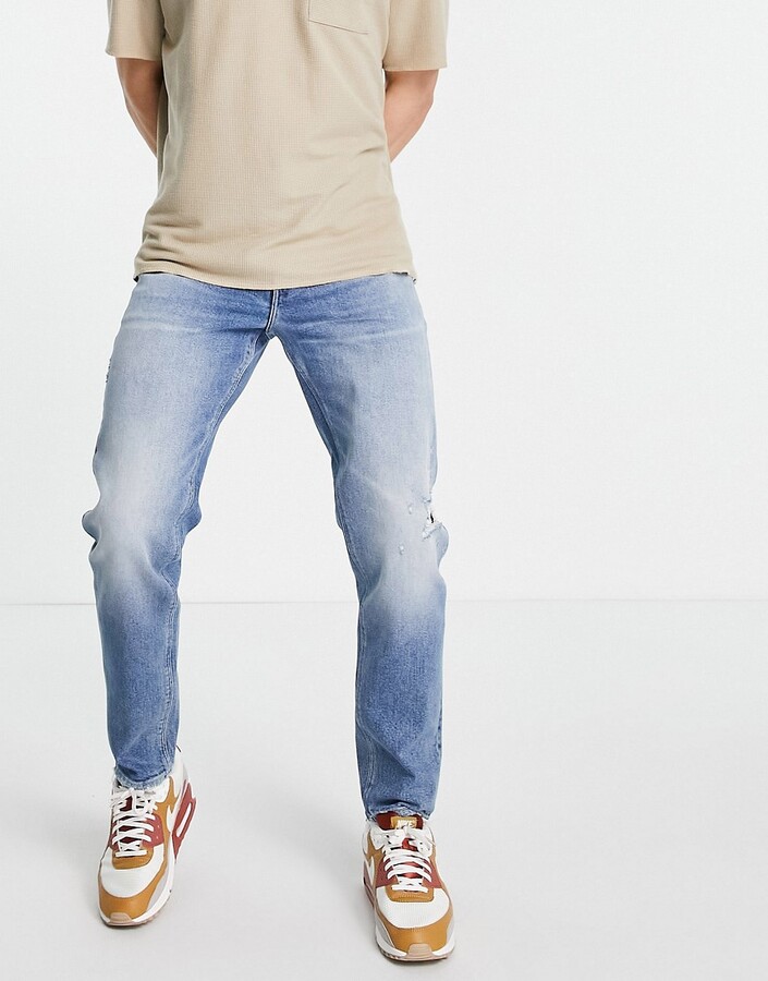 ASOS DESIGN stretch tapered jeans in vintage mid wash with rips - ShopStyle