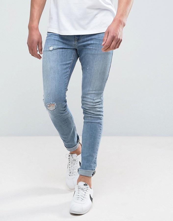 ASOS DESIGN super skinny jeans in mid wash blue with abrasions - ShopStyle