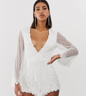 Starlet embellished plunge front playsuit with tassels in white