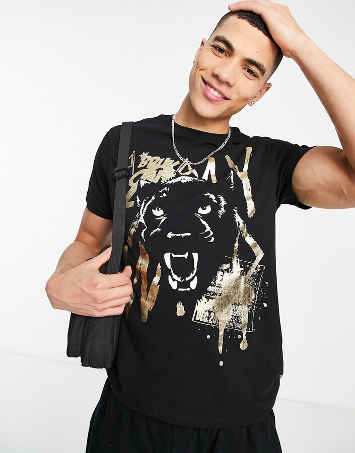 GUESS t-shirt with gold lion logo in black - ShopStyle