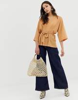 Thumbnail for your product : ASOS Tall DESIGN Tall textured oversized top with v neck and tie waist