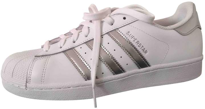 gold adidas superstar trainers