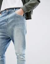 Thumbnail for your product : ASOS Design Drop Crotch Jeans In Mid Wash Blue With Rips