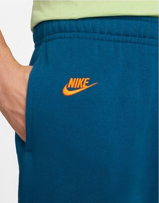 Nike Essentials fleece multi logo casual fit cuffed joggers in blue -  ShopStyle Trousers