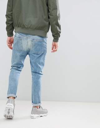 ASOS Design Drop Crotch Jeans In Mid Wash Blue With Rips