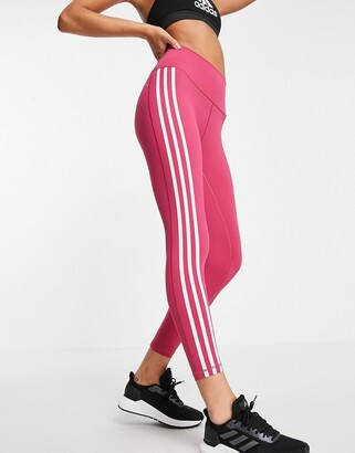 black adidas with pink stripes