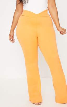 PrettyLittleThing Plus Orange Scuba Curve Waist Band Detail Flared Trousers