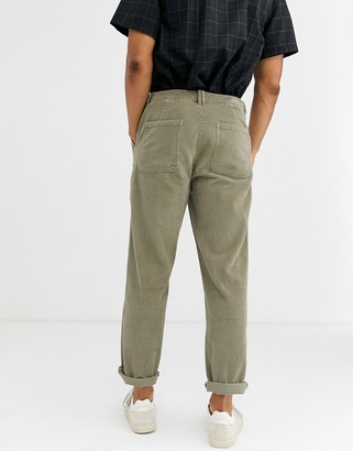 ASOS DESIGN relaxed cord pants with utility pockets in washed khaki