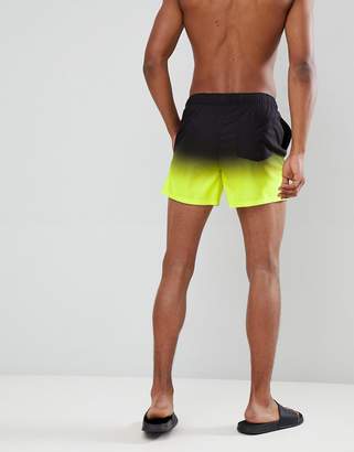 ASOS Design DESIGN swim shorts in black & neon yellow ombre short length