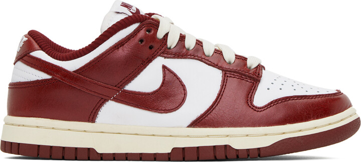 white nike sneakers with red swoosh