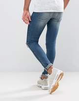 Thumbnail for your product : ASOS Design Extreme Super Skinny Jeans In Mid Wash With Rips And Side Stripe