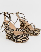 Thumbnail for your product : ASOS DESIGN DESIGN Tribute thong tie leg wedges in tiger