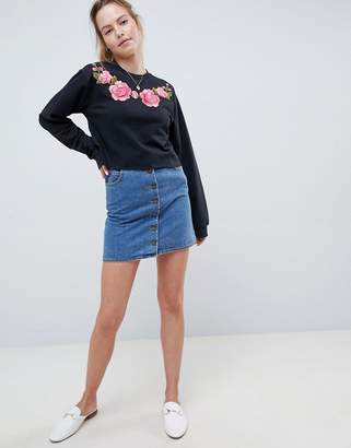 ASOS Design DESIGN sweatshirt with floral embroidery in washed black