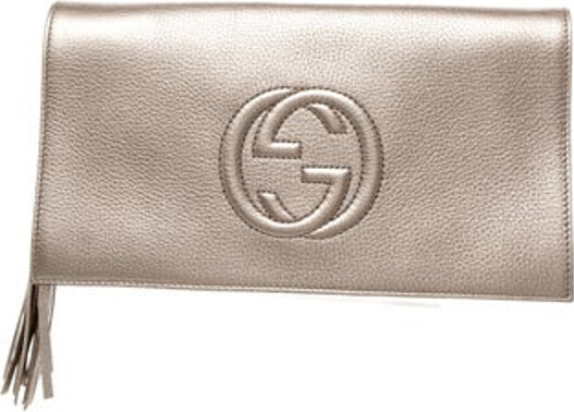 Gucci Clutch Metallic & Neutrals Leather Interlocking G Logo & Babouska Accents Gold-Tone Hardware Tassel Accents Canvas Lining & Dual Interior Pockets Flap Closure at Front Includes Dust Bag Unfortunately due to restrictions this item may not be eligible for shipping in all areas.