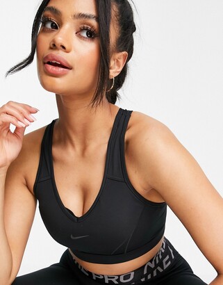 Nike Training Swoosh Futura graphic medium support sports bra in pink -  ShopStyle