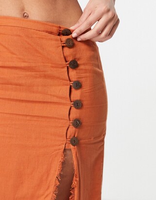 ASOS DESIGN midi skirt with raw edge and button detail in rust