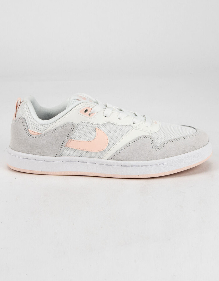 white and coral nike shoes