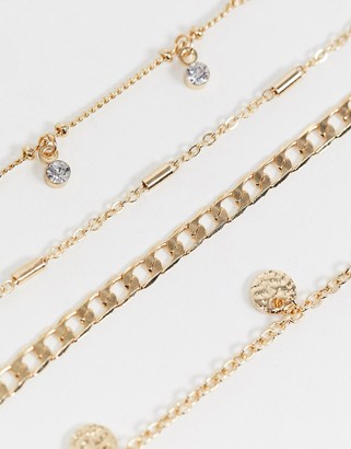 ASOS DESIGN pack of 4 anklets with fine curb chain and crystal disc charms in gold tone