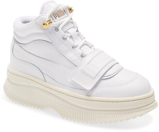 white and gold pumas with strap