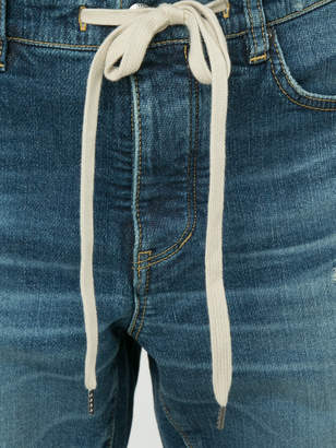 Attachment distressed slim-fit jeans