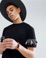 Thumbnail for your product : ASOS DESIGN festival relaxed longline t-shirt with geo-tribal coin sleeve taping