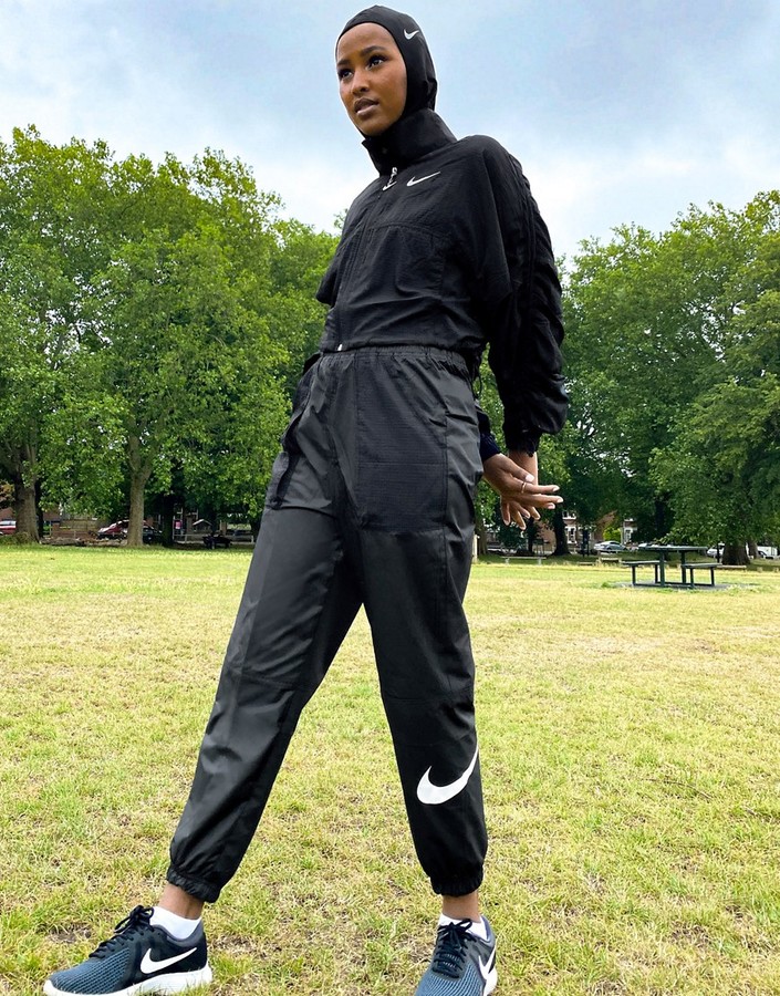 Nike woven swoosh cargo pants with belt in black - ShopStyle