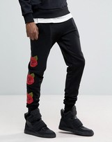 Thumbnail for your product : Criminal Damage Skinny Joggers In Black With Rose Print