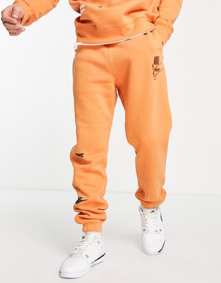 Nike Sport Essentials Multi Futura logo fleece joggers in orange -  ShopStyle Trousers