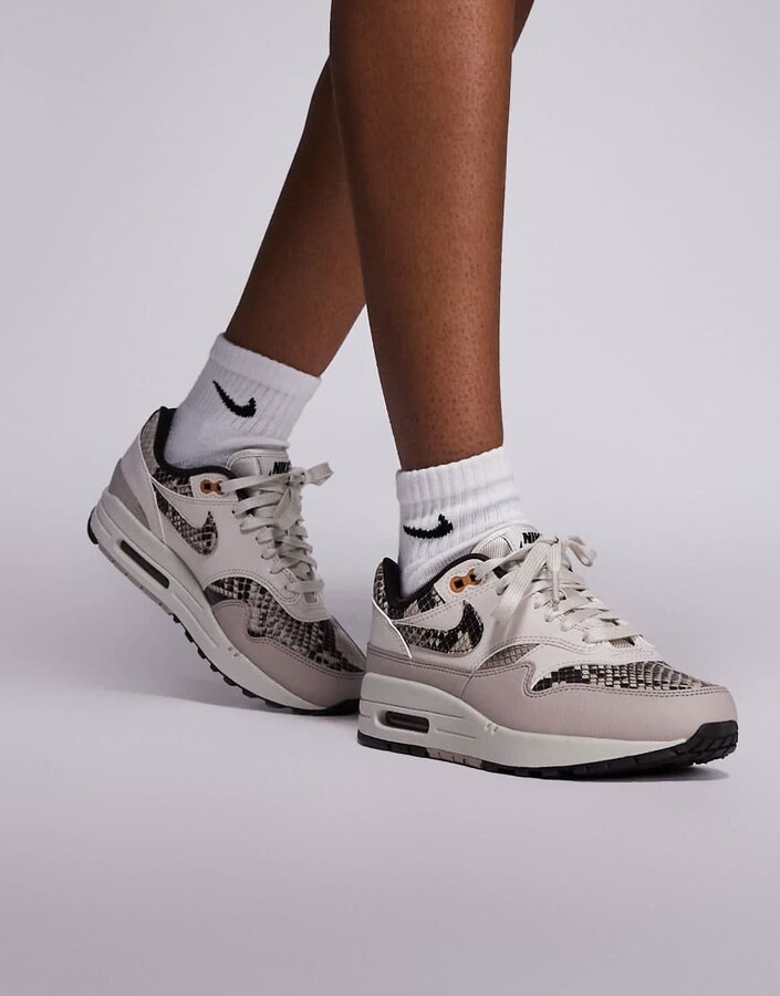 Nike Air Max 1 sneakers in white and snake print