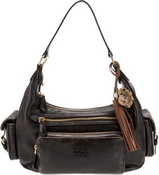 Miu Miu Shoulder Bag Brown Lambskin Gold-Tone Hardware Single Shoulder Strap Scalloped & Tassel Accents Five Exterior Pockets Satin Lining & Single Interior Pocket Zip Closure at Top Includes Dust Bag