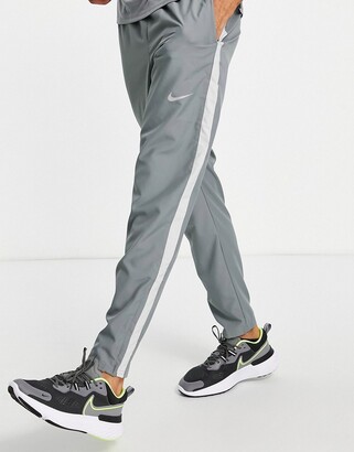Nike Running Dri-FIT Stripe woven pants in gray - ShopStyle
