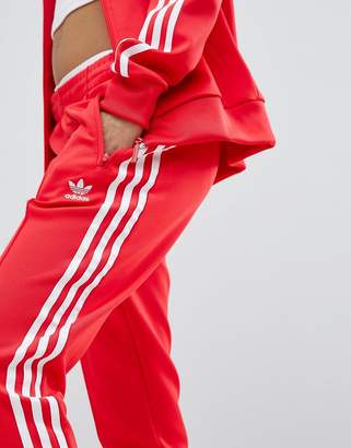 adidas adicolor Three Stripe Track Pants In Red - ShopStyle