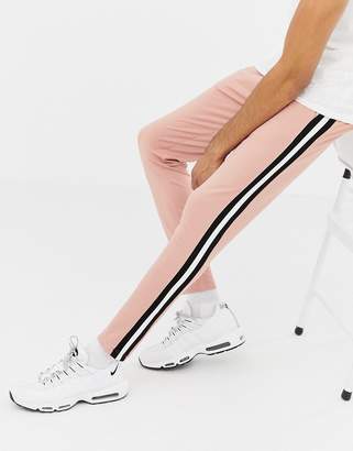 ASOS DESIGN tall skinny sweatpants in poly tricot with side stripe in pink