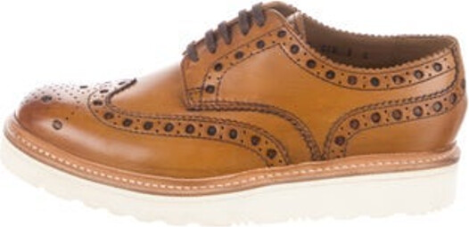 Grenson Leather Low Top Loafer Sneakers Brown Round-Toes with Lasercut Accents Lace-Up Closure at Uppers Includes Box Unfortunately, due to restrictions, this item may not be eligible for shipping in all areas.