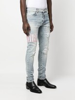 Thumbnail for your product : Amiri Tie Dye Core logo-embroidered distressed slim-cut jeans