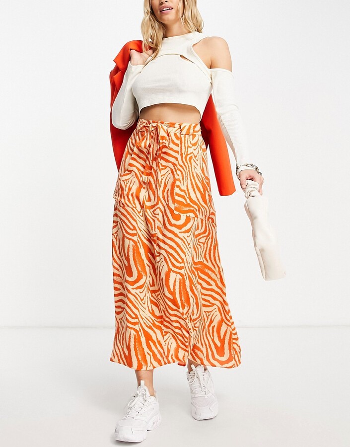 ASOS DESIGN wrap maxi skirt with pockets in orange zebra print