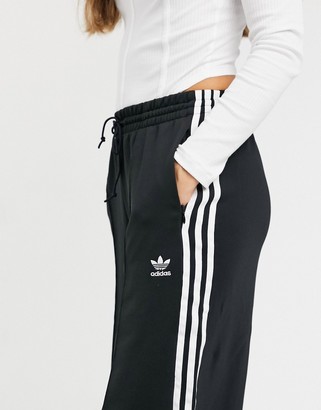 adidas adicolor three stripe wide leg pants in black - ShopStyle