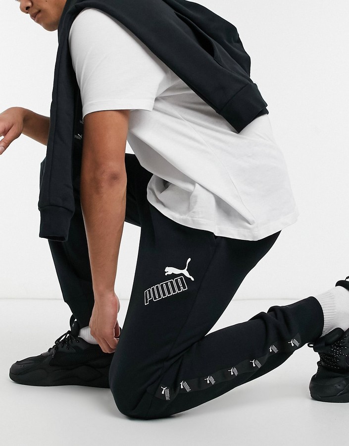 Puma Amplified leg tape logo sweatpants in black - ShopStyle Activewear  Pants