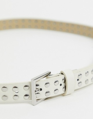 Accessorize studded belt with silver buckle in white