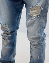 Thumbnail for your product : ASOS Drop Crotch Stacked Jeans With Rips And Bleaching In Mid Blue