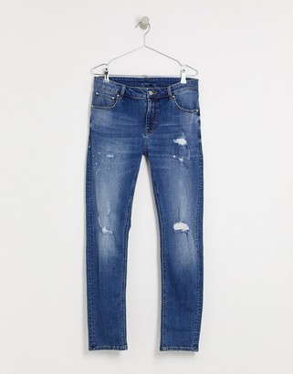 ASOS DESIGN skinny jeans in mid wash blue with rips and destroy