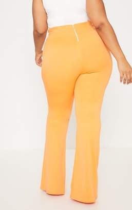 PrettyLittleThing Plus Orange Scuba Curve Waist Band Detail Flared Trousers