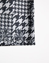 Thumbnail for your product : ASOS DESIGN polo shirt in dogstooth & baroque all over print