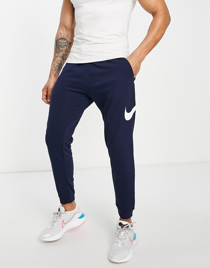 Nike Training Swoosh Dri-FIT tapered joggers in navy - ShopStyle Trousers