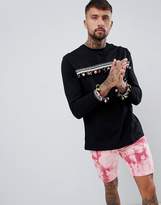 Thumbnail for your product : ASOS DESIGN festival relaxed longline long sleeve t-shirt with pom-pom chest and cuff