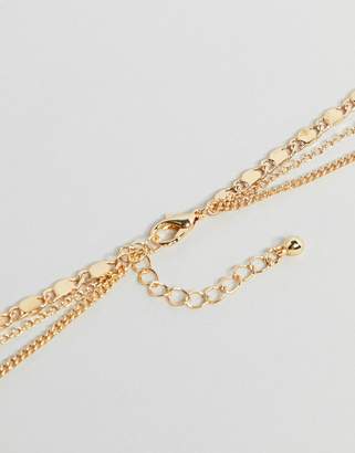ASOS Design DESIGN multirow necklace with mixed chains and vintage style charms in gold