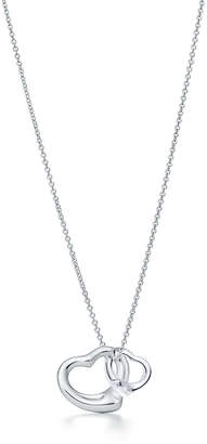 Tiffany & Co. Elsa Peretti® Open Heart pendant of sterling silver and rock crystal.