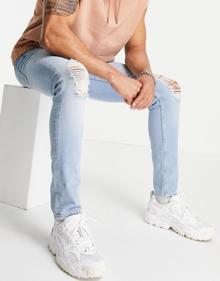 ASOS DESIGN skinny jeans in light wash blue with knee rips - ShopStyle