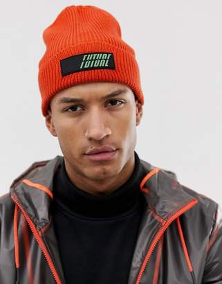 ASOS DESIGN oversized beanie in orange with rubber badge detail