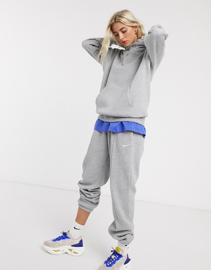 Nike mini Swoosh oversized joggers in grey ShopStyle Trousers